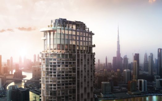 Un gratte-ciel moderne au premier plan, qui rappelle le SLS Dubaï, se dresse sur un horizon composé de nombreux immeubles de grande hauteur sous un lever de soleil doré. Le paysage urbain évoque un sentiment de développement et de modernité