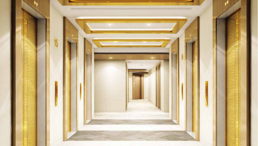 Un couloir d&#039;hôtel luxueux sur Imperial Avenue présentant un design épuré et moderne avec des accents dorés, des luminaires élégants et des portes numérotées.