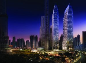 Un paisaje urbano nocturno de rascacielos iluminados con diseños elegantes y modernos contra un cielo oscuro en un entorno urbano cerca del Address Residences Dubai Opera.