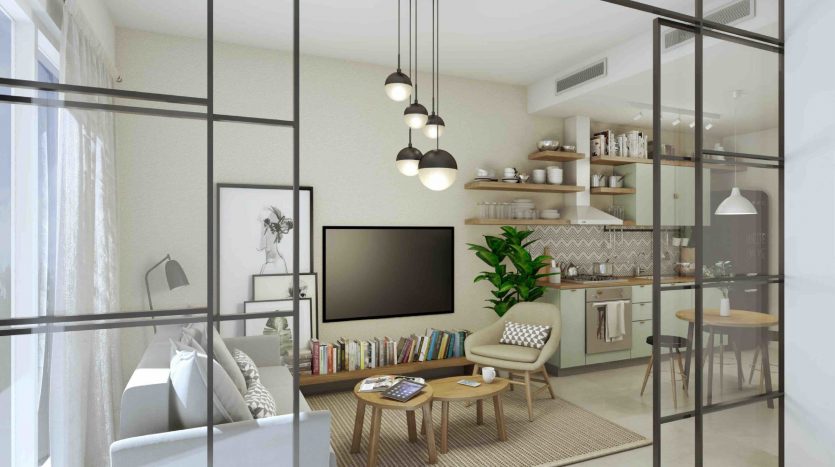 Salon moderne vu à travers une grande cloison vitrée dans le Collective 2.0 Dubai Hills, comprenant un coin salon confortable, une télévision à écran plat, des étagères ouvertes avec des livres et un espace salle à manger en arrière-plan
