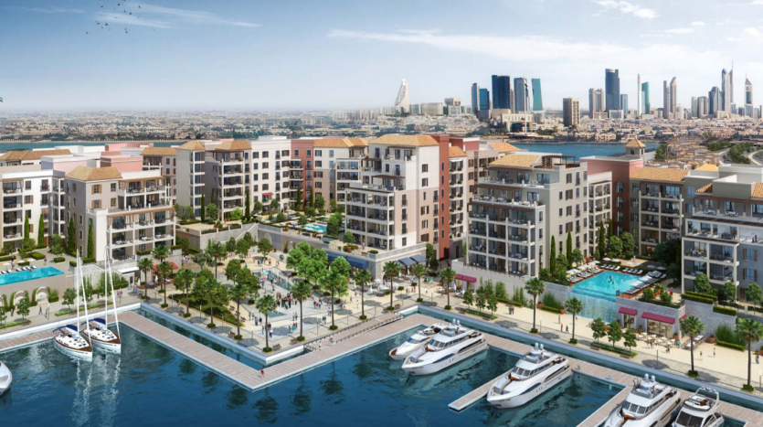 Une communauté dynamique en bord de mer à La Voile Port De La Mer avec des bâtiments résidentiels luxueux, une marina avec des yachts, un aménagement paysager luxuriant et une promenade animée, sur fond d&#039;horizon urbain moderne.