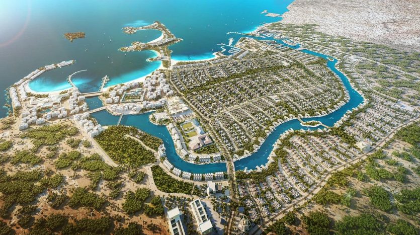 Vue aérienne d&#039;une ville balnéaire côtière avec une île distinctive en forme de dauphin au centre, entourée de marinas, de verdure luxuriante et de zones résidentielles selon les distinctions al jure.