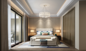 Habitación elegante y moderna con cama extragrande con almohadas decorativas, panel artístico en la pared, lámpara de araña, banco y puerta corredera que da a un balcón en una de las mejores urbanizaciones de Dubai.