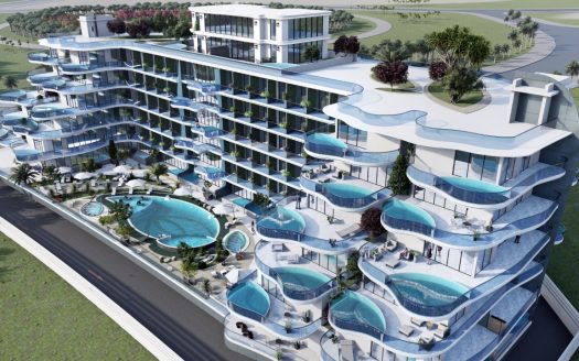 Vue aérienne d&#039;un hôtel moderne de plusieurs étages en bord de mer doté de balcons avec piscines privées, de terrasses paysagées et d&#039;une grande piscine centrale, situé dans le parc Samana avec vue sur la verdure luxuriante.