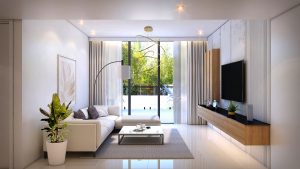 Salon moderne du Prime Residency 3 avec des meubles blancs élégants, une grande télévision sur panneau en bois, de hautes fenêtres avec des rideaux transparents et des plantes d'intérieur. Lumineux et aéré avec un design minimaliste.