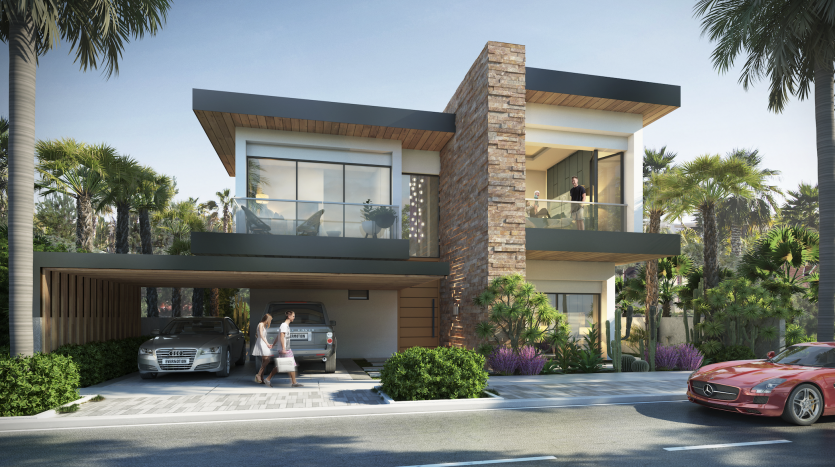 Une maison moderne de deux étages à Damas Hills 3 avec de grandes fenêtres en verre et des accents de pierre. Une femme fait signe depuis l’allée où sont garées deux voitures. Une verdure luxuriante entoure la maison.