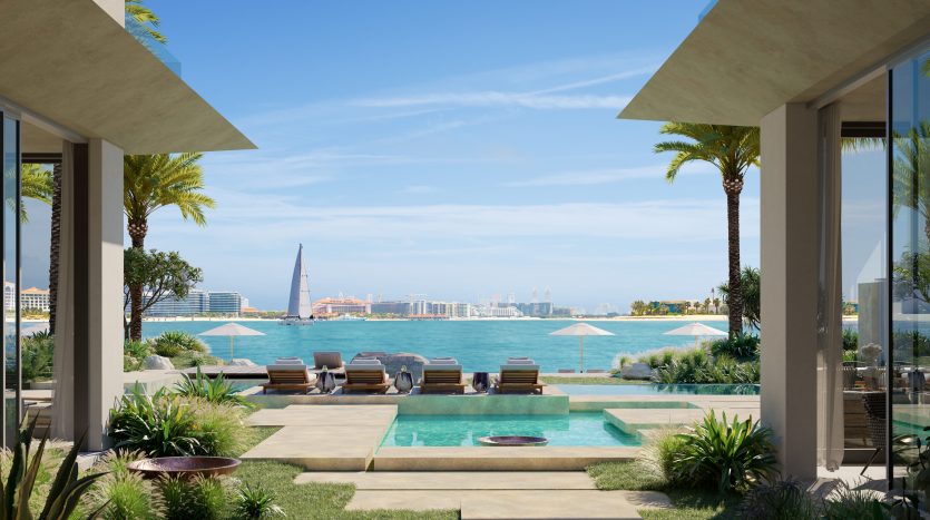 Luxueuse terrasse de villa en bord de mer avec piscine à débordement surplombant un océan bleu serein, flanquée de palmiers et d&#039;une architecture moderne Six Senses, avec un horizon de ville lointain.
