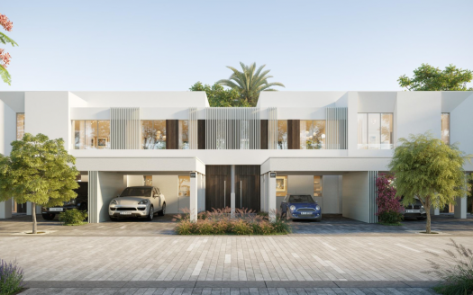 Une maison blanche moderne de deux étages à Talia the Valley, dotée de grandes fenêtres et portes en verre, entourée d'une verdure luxuriante et de palmiers, avec deux voitures garées dans un abri de voiture intégré.