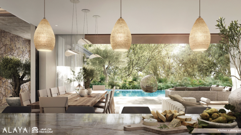 Une cuisine et une salle à manger modernes et ouvertes à Tilal Al Ghaf se marient parfaitement avec un jardin extérieur et une piscine, avec des matériaux naturels et de grandes fenêtres en verre offrant une vue sur la verdure luxuriante et