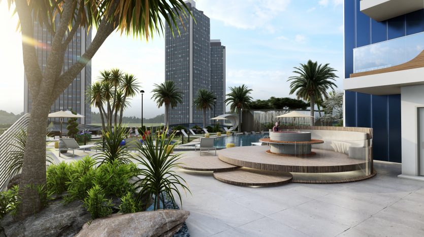 Piscine extérieure luxueuse d&#039;un hôtel de grande hauteur à Samana Waves, Dubaï, avec des palmiers, des chaises longues et un coin salon circulaire unique, entouré de tours modernes sous un ciel dégagé