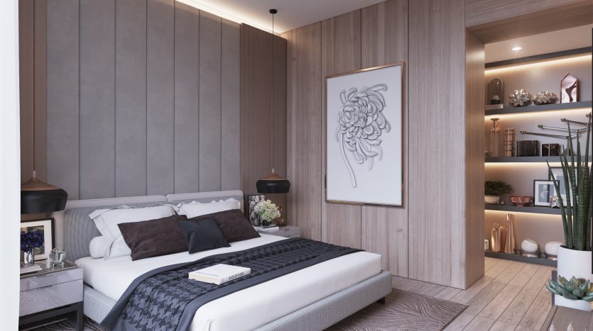 Une chambre moderne dans une villa à Dubaï comprenant un grand lit avec une literie grise et noire, des murs en panneaux de bois, une œuvre d&#039;art décorative encadrée et une étagère attenante remplie de livres et de décorations.