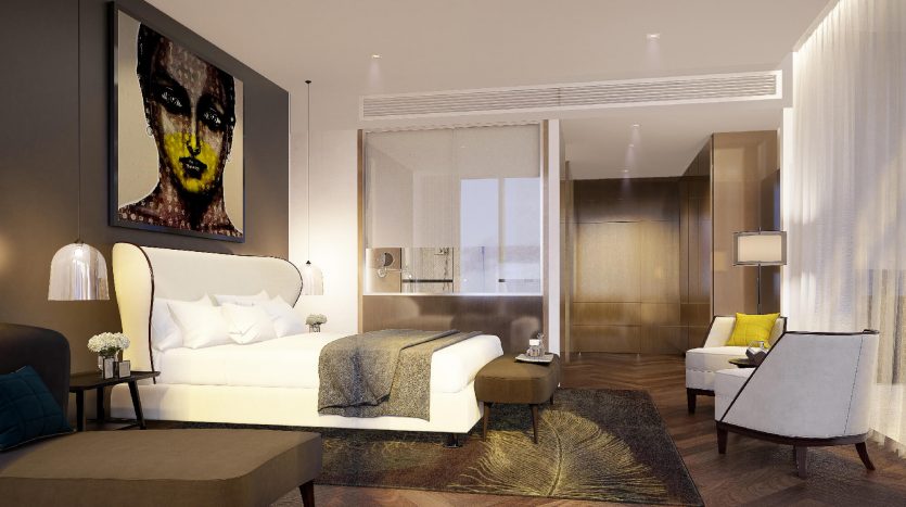 Une chambre d&#039;hôtel moderne à Dubaï comprenant un grand lit avec une tête de lit blanche, des meubles contemporains et une œuvre d&#039;art abstraite saisissante au-dessus d&#039;une table d&#039;appoint. Un éclairage doux et une décoration élégante créent une ambiance chaleureuse