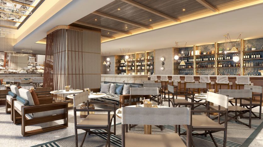 Villa spacieuse et élégante à Dubaï comprenant des tables et des chaises modernes en bois, des canapés moelleux et un bar bien approvisionné avec des étagères rétroéclairées sous un plafond à caissons chaleureusement éclairé.