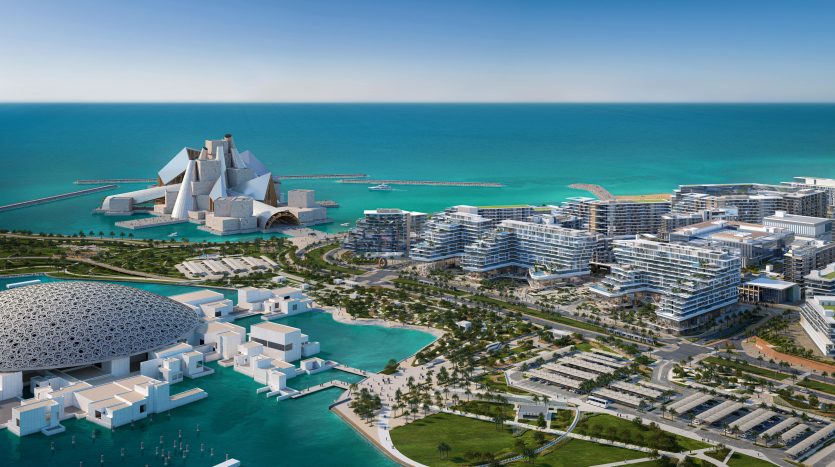 Vue aérienne d&#039;un paysage urbain côtier moderne avec des bâtiments architecturaux uniques à Dubaï et des eaux bleu clair, entourés de verdure luxuriante et de passerelles.