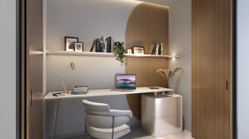 Un coin bureau moderne dans une villa de Dubaï avec un bureau intégré, des étagères remplies de livres et de photos encadrées et un éclairage ambiant. Une chaise élégante et un ordinateur portable blanc élégant complètent l&#039;espace.