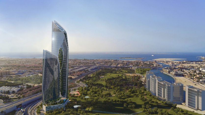 Vue aérienne d'un gratte-ciel futuriste en verre au design incurvé surplombant un paysage urbain côtier avec des parcs verdoyants et un ciel bleu clair à Dubaï.