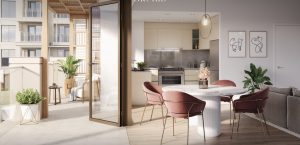 Intérieur d'appartement moderne à Dubaï comprenant un coin repas avec une table ronde en marbre et des chaises roses, relié à une cuisine élégante et un balcon extérieur, baigné de lumière naturelle.