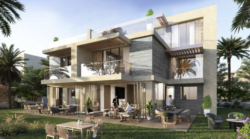 Une maison moderne de deux étages à Dubaï avec de vastes balcons, de grandes fenêtres en verre et des finitions extérieures en bois et en pierre. On voit des gens se détendre sur des meubles de patio dans un jardin luxuriant.