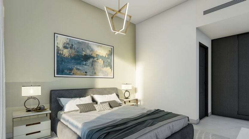 Une chambre moderne dans un appartement de Dubaï comprenant un lit gris avec des oreillers décoratifs, deux lampes de chevet sur des tables de nuit blanches, une grande peinture abstraite au-dessus du lit et un plafonnier géométrique unique.