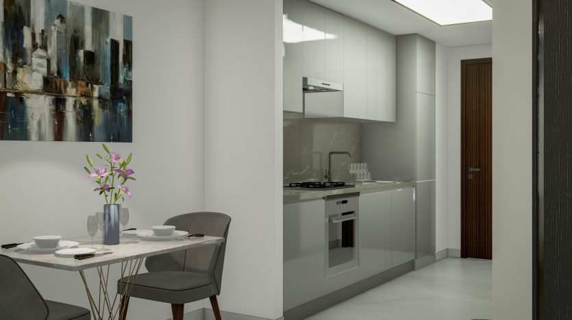Une cuisine et un coin repas modernes avec des armoires blanches, une cuisinière intégrée et une table pour deux. Un tableau abstrait est accroché au mur et une orchidée est placée