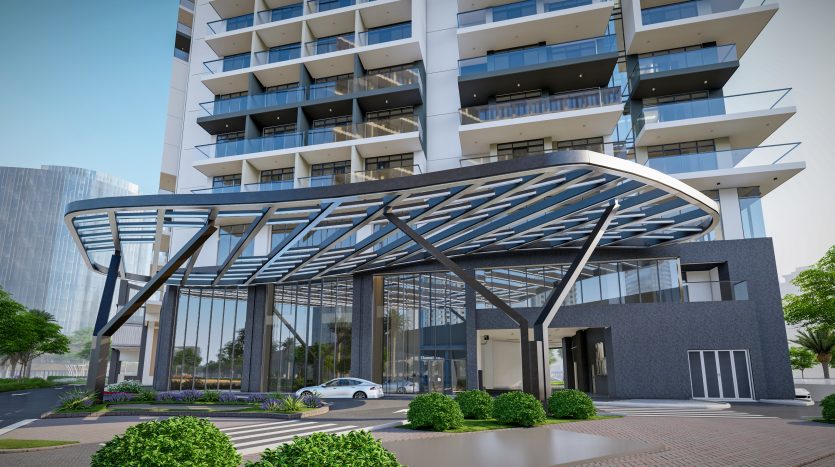 L&#039;entrée d&#039;un immeuble moderne à Dubaï présente un élégant auvent métallique incurvé sur des portes en verre, avec un bâtiment à plusieurs étages avec des balcons en arrière-plan.