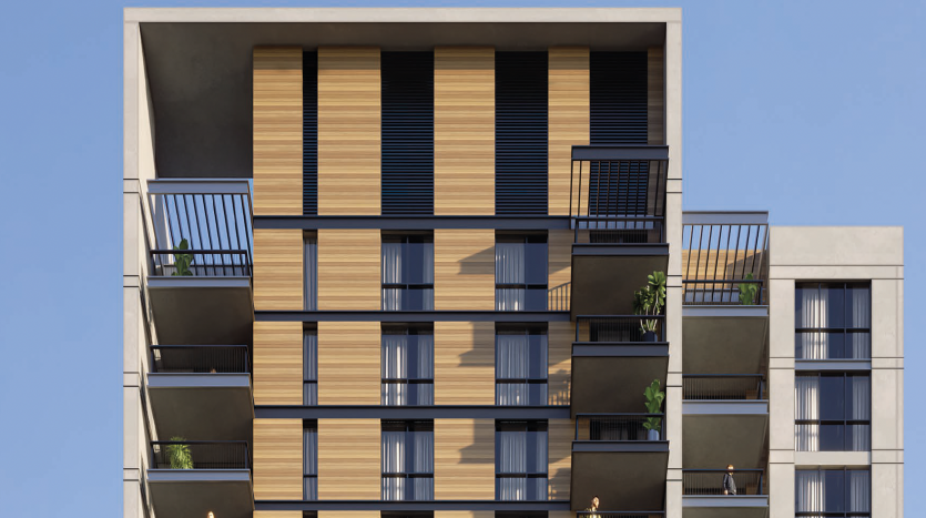 Façade d&#039;immeuble d&#039;appartements moderne présentant un mélange de lambris en bois et de béton gris, avec des balcons sur un ciel bleu clair à Dubaï.