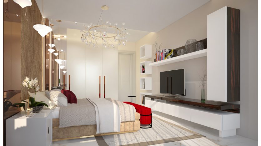 Une chambre moderne et élégante dans une villa de Dubaï comprenant un grand lit avec des draps beiges, des étagères intégrées blanches, une télévision à écran plat et un coin salon confortable avec des poufs rouges. Porcherie