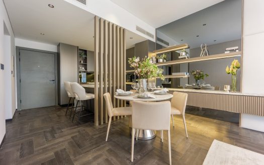 Cuisine et salle à manger modernes dans un appartement de Dubaï avec un mobilier élégant, une table à manger en bois pour deux personnes, des comptoirs de cuisine élégants et des fleurs décoratives, avec un parquet à chevrons et une palette de couleurs neutres