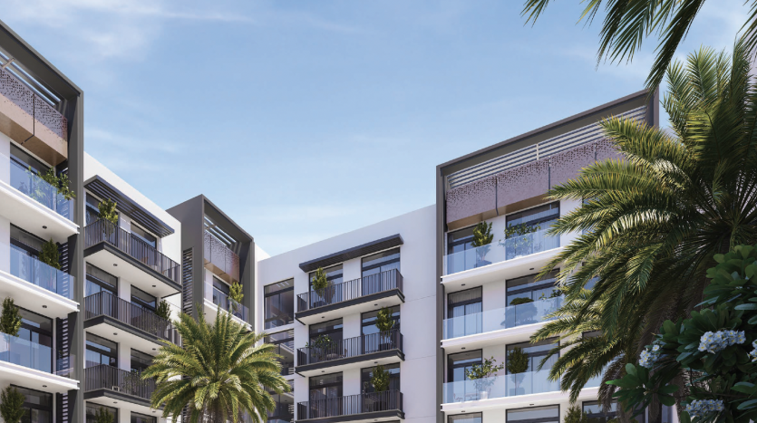Immeubles de villas modernes avec balcons, verdure luxuriante et palmiers sous un ciel bleu clair.