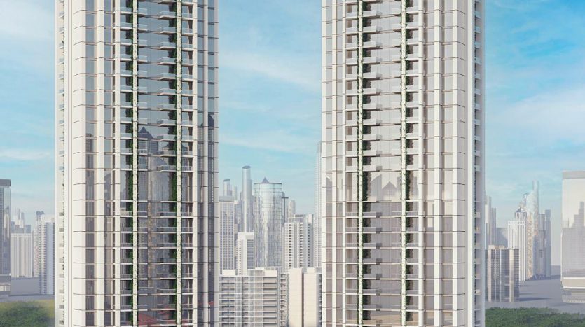 Deux gratte-ciel hauts et élégants avec des façades en verre réfléchissantes se tenant côte à côte sous un ciel bleu clair, entourés d&#039;arbres verts et d&#039;un horizon de la ville en arrière-plan, présentant les principales opportunités d&#039;investissement à Dubaï.