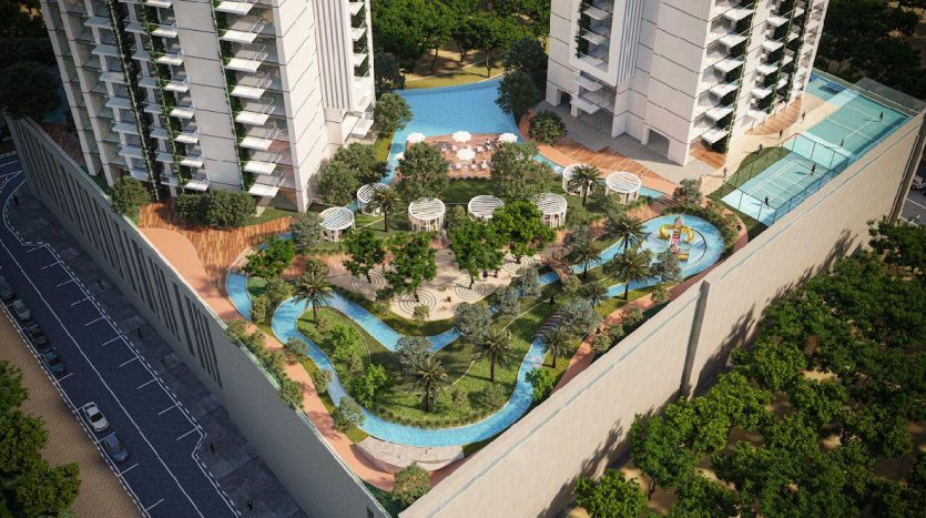 Vue aérienne d&#039;un complexe résidentiel luxueux à Dubaï comprenant des piscines incurvées, une verdure luxuriante, des espaces de détente et des immeubles modernes de grande hauteur par une journée ensoleillée.