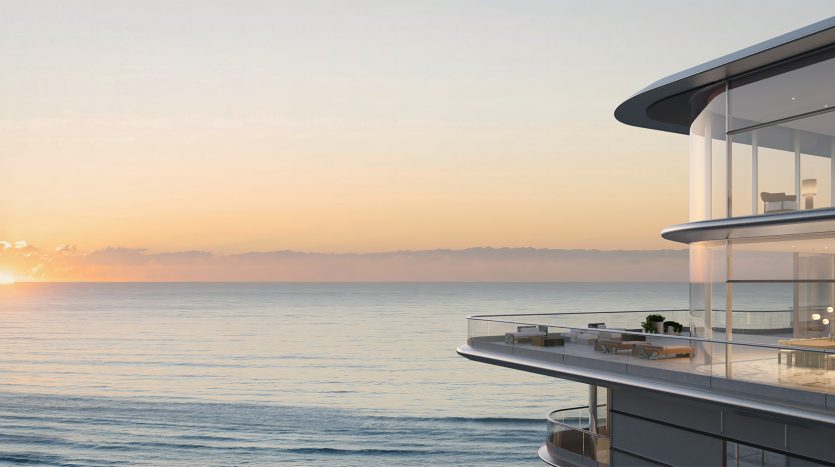 Une maison de luxe moderne à la façade vitrée surplombant l&#039;océan au coucher du soleil, avec un ciel clair et une mer calme, idéale pour un investissement sur le marché immobilier de Dubaï.