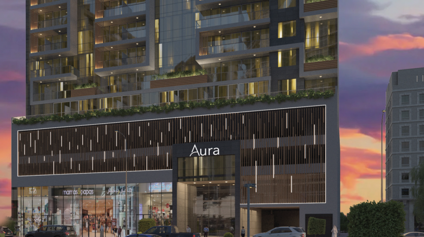 Une représentation artistique d'un bâtiment moderne nommé "aura" avec un mélange d'espaces résidentiels et commerciaux, dont l'appartement dubaï, magnifiquement éclairé au crépuscule avec une activité de rue animée.