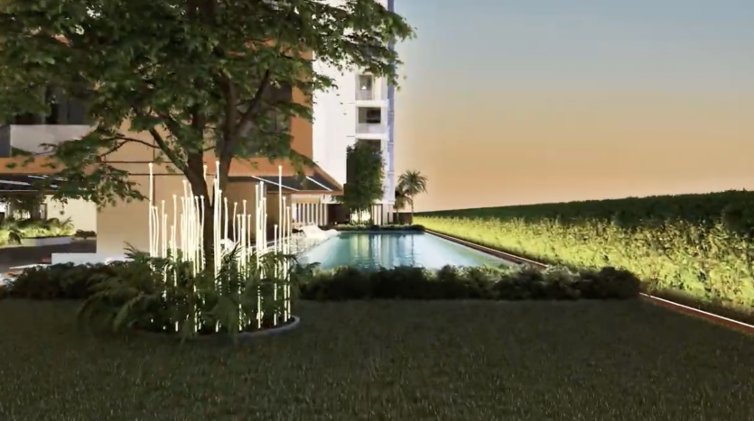 Une scène extérieure sereine au crépuscule avec une piscine étroite réfléchissante flanquée d'une verdure luxuriante et un appartement moderne à plusieurs étages à Dubaï. Un éclairage doux améliore l’ambiance tranquille.