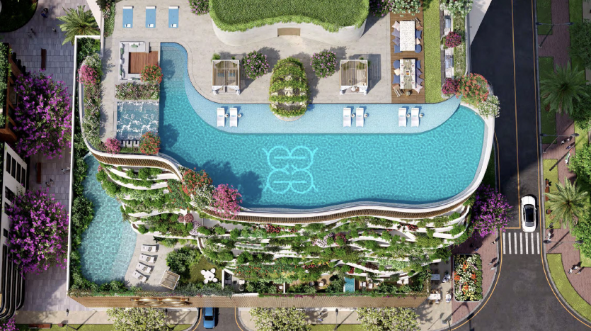 Vue aérienne d&#039;une luxueuse piscine sur le toit de Dubaï avec un design courbé unique, entourée de plantes vertes luxuriantes et équipée de chaises longues et de cabanes.