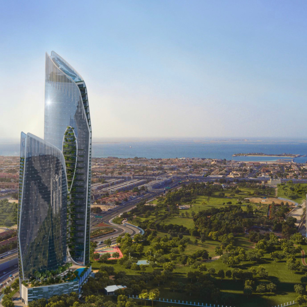 Vue aérienne d'un gratte-ciel futuriste doté d'une élégante façade en verre incurvée surplombant un paysage urbain côtier de Dubaï avec des parcs verdoyants et un ciel dégagé.