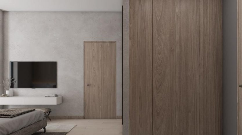 Chambre minimaliste moderne dans une villa de Dubaï comprenant une grande armoire en bois, une télévision murale et un lit moelleux dans une chambre avec des éléments de décoration en béton et en bois.