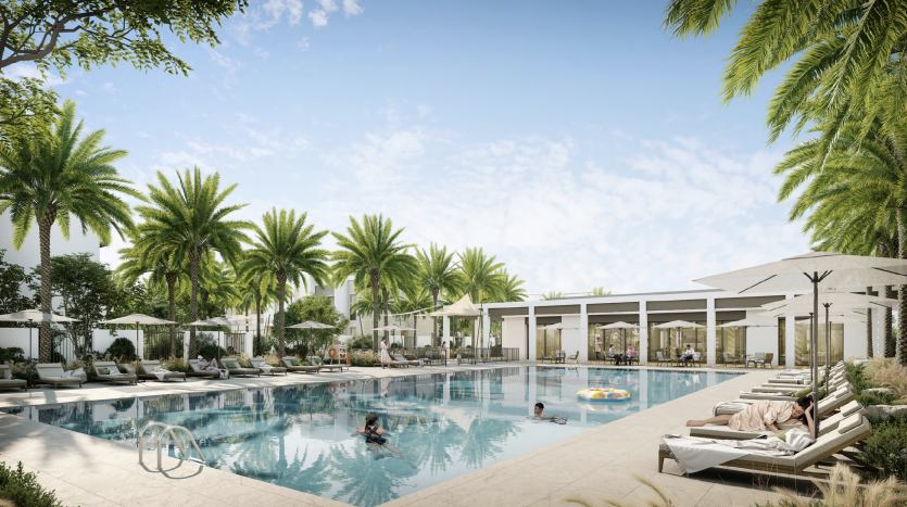 Une luxueuse piscine extérieure entourée de palmiers, dotée de plusieurs chaises longues, de parasols et de personnes profitant de l&#039;eau et prenant un bain de soleil. La villa blanche moderne de Dubaï encadre la piscine.