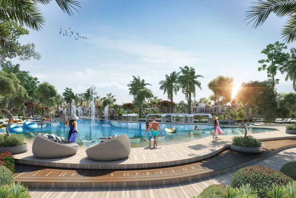 Une scène de piscine animée avec des chaises longues, une verdure luxuriante et des gens profitant d'une journée ensoleillée. Le décor présente des plantes tropicales et une architecture moderne sous un ciel clair à Dubaï.