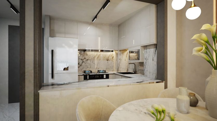 Cuisine moderne dans un appartement de Dubaï avec comptoirs en marbre, armoires blanches et appareils électroménagers de pointe, avec table à manger ronde et luminaire suspendu élégant.