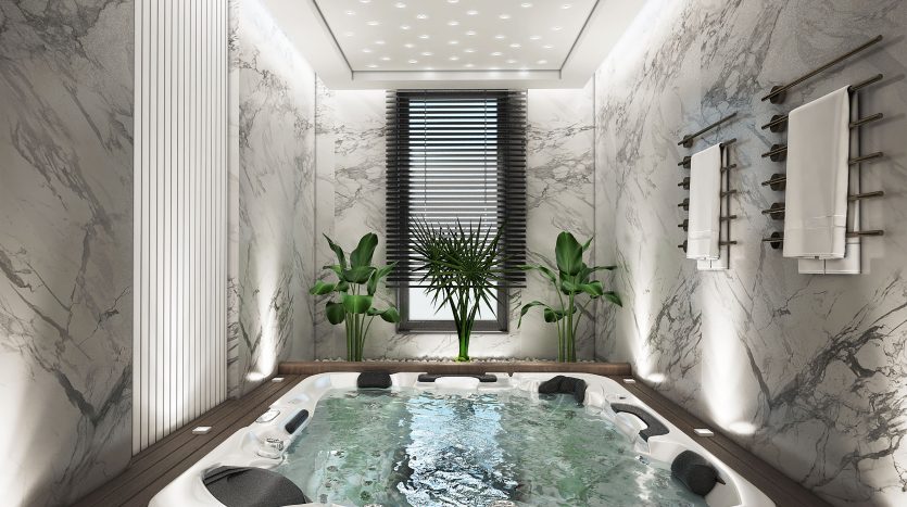 Luxueuse salle de jacuzzi intérieure dans une villa de Dubaï avec des murs en marbre, du parquet, des plantes tropicales, une grande fenêtre avec stores et un éclairage ponctuel au plafond.