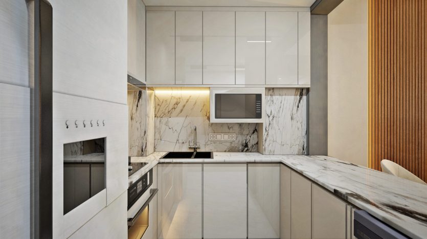 Une cuisine moderne dans une villa de Dubaï avec des comptoirs et un dosseret en marbre, des appareils électroménagers en acier inoxydable, des armoires blanches et un mur d&#039;accent en bois.