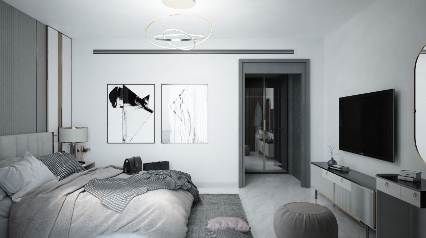 Une chambre moderne et monochrome dans un appartement de Dubaï comprenant un lit soigneusement fait avec des couvertures à rayures, des œuvres d&#039;art murales abstraites, un plafonnier circulaire et un meuble TV élégant. Une porte ouverte montre un aperçu