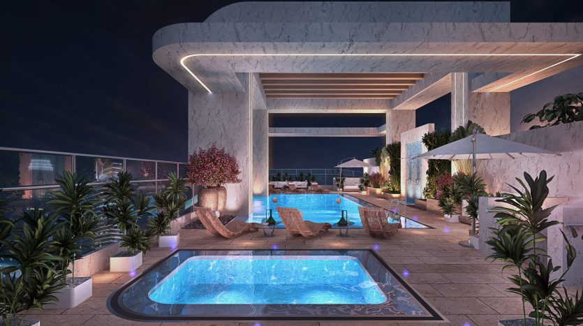 Un luxueux espace piscine sur le toit la nuit, doté d&#039;un jacuzzi éclairé, d&#039;une piscine et entouré d&#039;une verdure luxuriante et d&#039;une architecture moderne, parfait pour un investissement à Dubaï.
