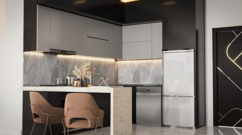 Une cuisine moderne avec des armoires grises élégantes, un dosseret en marbre et un îlot avec deux chaises. Il y a un réfrigérateur en acier inoxydable et des luminaires géométriques, parfaits pour Investissement Dubaï.