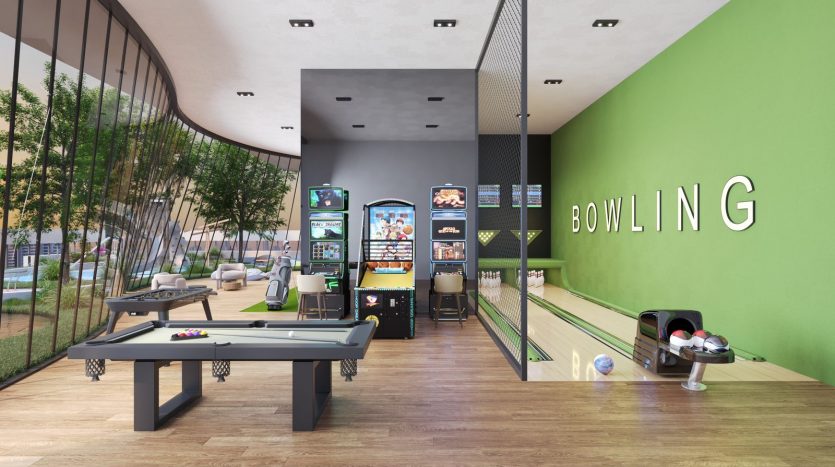 Intérieur d&#039;une piste de bowling moderne avec une signalisation claire, comprenant une table de billard, des jeux d&#039;arcade et des pistes de bowling. Des murs vert vif et un mobilier élégant et épuré créent un espace de loisirs accueillant, idéal pour investir à Dubaï.