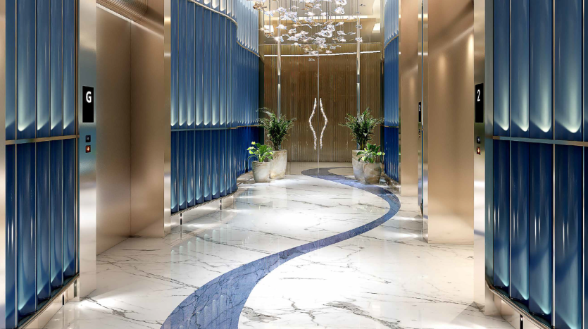 Un hall d&#039;ascenseur moderne dans un luxueux appartement de Dubaï avec des portes bleues élégantes, des sols en marbre et un tapis bleu courbé. Éclairage artistique et décorations végétales renforcent l&#039;atmosphère somptueuse.