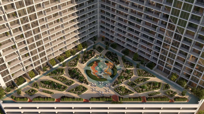 Vue aérienne d&#039;une cour entourée d&#039;immeubles d&#039;habitation de grande hauteur à Dubaï, comprenant un jardin paysager avec des allées, des bancs et une fontaine centrale.