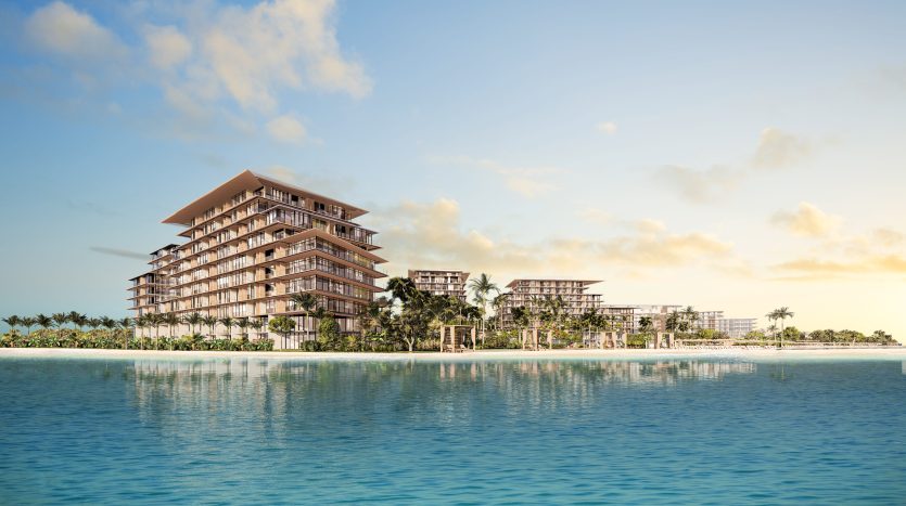 Un complexe moderne en bord de mer avec plusieurs villas à Dubaï entourées de palmiers, sur un ciel bleu clair et une mer calme au lever du soleil.