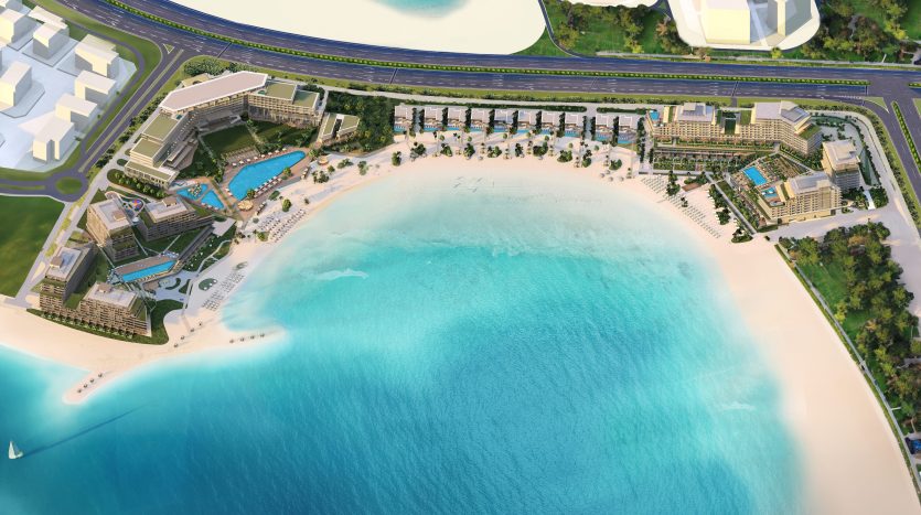 Vue aérienne d&#039;un complexe tropical avec une plage de sable immaculée, une eau turquoise cristalline et un aménagement paysager verdoyant, entouré de plusieurs villas de Dubaï et d&#039;une route.